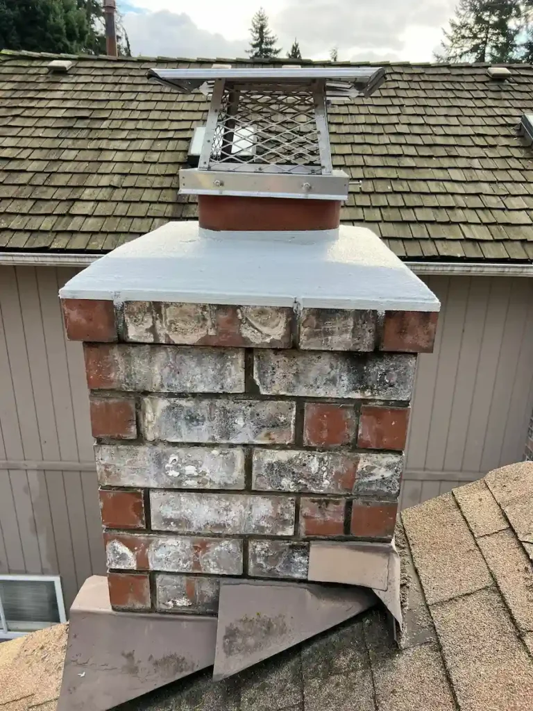 Chimney repair with new chimney cap installation on brick chimney in Monroe WA