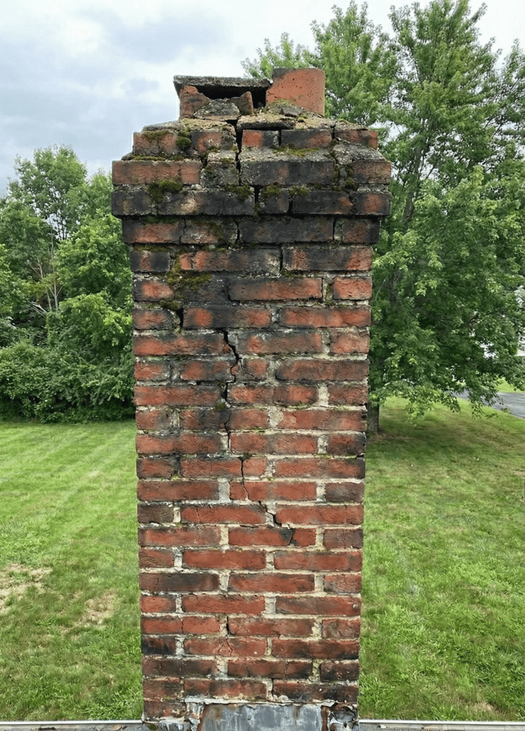 Damaged chimney showing crumbling bricks and structural issues - top one chimney