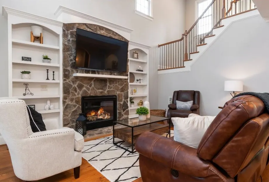 Cozy living room with a stone fireplace and modern decor.